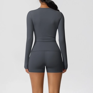 Back view of dark grey long-sleeve yoga top and high-waist shorts set showing athletic fit