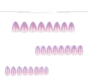 Close-up of almond-shaped purple gradient press-on nails with shiny silver glitter powder