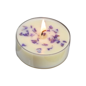 Handmade scented tea light candle with purple dried flower petals in a clear container