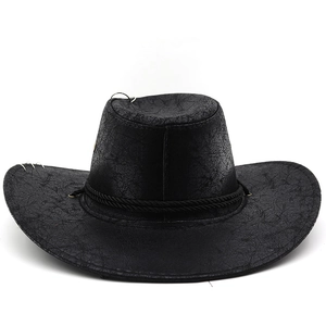 Detail of vintage black cowboy hat with faux leather texture and silver rings on brim