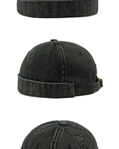 Dettaglio del berretto docker in denim nero lavato con fibbia in metallo e trama in twill
