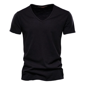 Detailed view of black V-neck t-shirt featuring natural slub cotton fabric texture