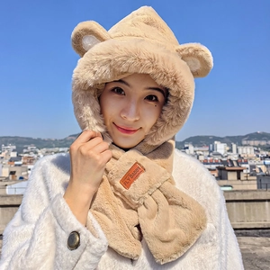 Close-up of khaki plush hooded scarf with cute bear ears and premium leather brand tag