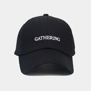 Close-up of white 3D embroidery on black cotton twill baseball cap with gathering text