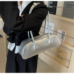 Detail of minimalist large capacity silver underarm bag with sleek metallic finish