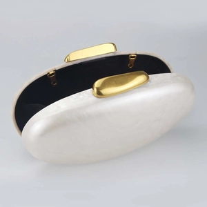 Elegant pearl white shell acrylic clutch bag with gold frame and black fabric lining