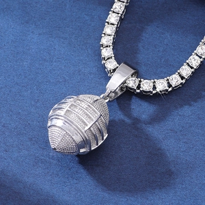 Macro detail of silver rugby helmet pendant featuring sparkling paved cubic zirconia stones