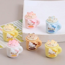 Macro shot of cute resin Hello Kitty cat mugs with cream and sprinkles for DIY crafts