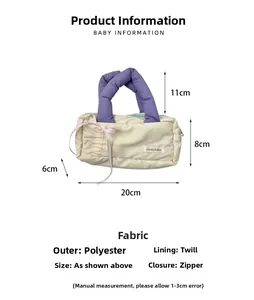 Detail of beige and purple quilted pencil case showing zipper and fabric texture