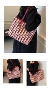 Detail of red and beige houndstooth tote bag featuring elegant heart-pattern weaving