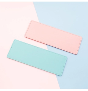 Macro detail of slim pink and mint leather card holders with fine stitching work