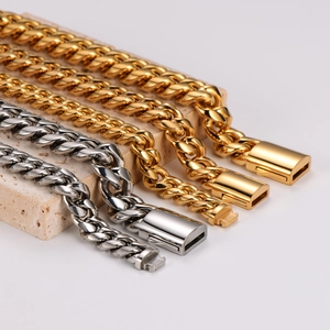 Polished gold and silver Cuban link necklaces with sturdy clasps on stone base
