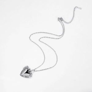 Detailed view of silver heart-shaped locket pendant necklace in polished stainless steel