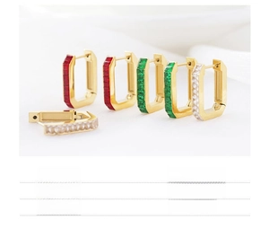 Close-up of U-shaped stainless steel earrings with red, green, and white zircon stones