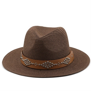 Detail of dark brown straw fedora featuring a leather band with silver studded accents