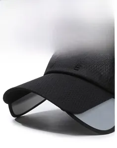Detail of a black baseball cap featuring a wide brim and 3D VOGUE embroidery text