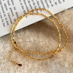 Detail of S925 sterling silver gold beaded chain with lobster clasp and adjuster