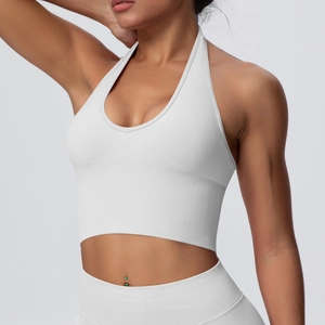 Detail of white halter-neck sports bra with vertical ribbed texture and slim-fit cut