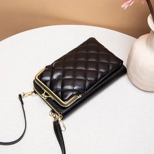 Elegant black quilted phone bag with gold metal clasp on a stylish stone tabletop