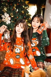 Close-up of festive Christmas knit sweaters with cartoon bear and cozy holiday decor
