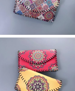Close-up of mandala pattern cross-body phone bags with hand-stitched leather edges