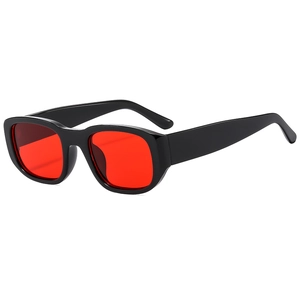 Retro sunglasses with thick black frames and bright red lenses in a stylish side view