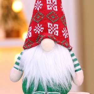 Close-up of a Christmas gnome doll featuring a knitted snowflake hat and plush white beard