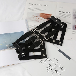 Women's punk style black elastic harness belt with silver buckles on modern magazines