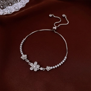 Close-up of adjustable silver flower bracelet with sparkling cubic zirconia on velvet