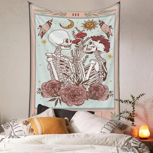 Detail view of III Tarot skull tapestry with floral patterns hanging above a cozy bed