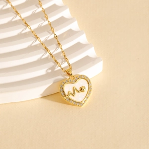 Golden heart pendant necklace with shell inlay and zircon accents on a wavy stand