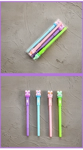 Close-up of four colorful cartoon rabbit gel pens in purple blue pink and green sets
