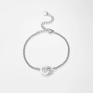 Detailed close-up of interlocking rings with crystals on a stainless steel chain