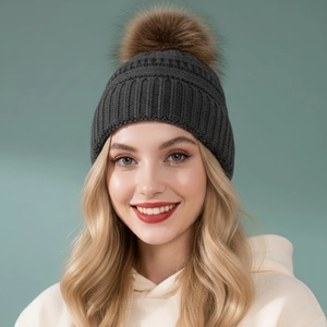 Winter knit beanie for adults in dark grey with a fluffy brown faux fur pom-pom