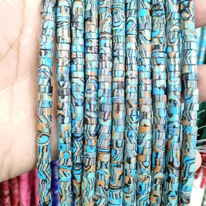 Macro detail of 6mm flat disc Heishi beads with blue and brown swirl stone texture