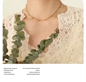 Detail of 18k gold plated surgical titanium steel beaded chain necklace on neck