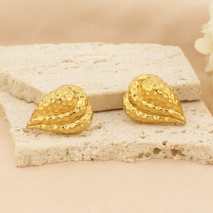 Detailed view of 18k gold plated heart earrings with hammered texture on stone base