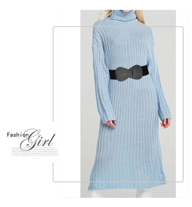 Detail of a black elastic cinch belt with a grey bow buckle on a blue dress