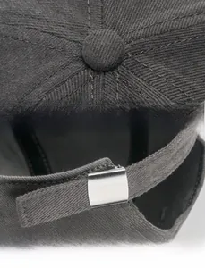 Detail of gray twill cotton baseball cap showing top stitching and adjustable metal buckle