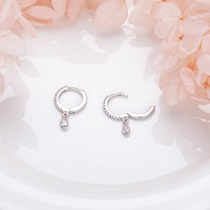 Detailed macro view of S925 sterling silver hoop earrings with a sparkling teardrop zircon