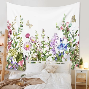 Detail of bohemian tapestry featuring hand-painted flowers and butterflies on bedroom wall