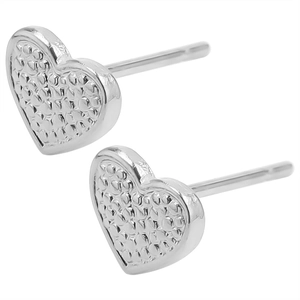 Detailed view of silver heart earrings with vintage hammered metal texture on white background