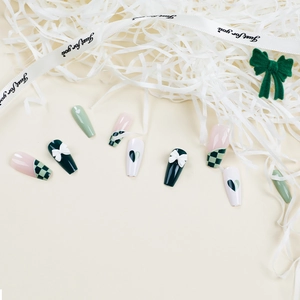 Green checkerboard press-on nails with 3D white bows and heart patterns in ballet shape