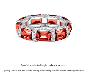 Detail of emerald cut red stones on silver eternity ring with pavé-set accents