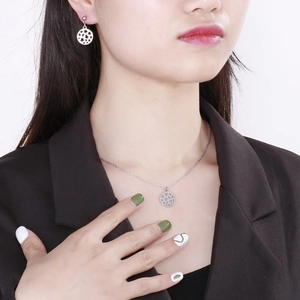 Silver hollow star pendant necklace and earrings jewelry set worn by a fashion model