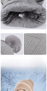 Detail of soft plush lining and knitted texture on thermal winter beanie with faux fur pom