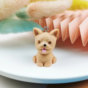 Detail of light brown French Bulldog resin charm for DIY jewelry with metal loop