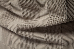 Macro shot of striped hollow-out knit fabric on a men's polo shirt with rib textures