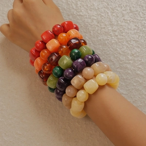 Colorful acrylic beaded bracelets set showing mixed square and round beads on wrist