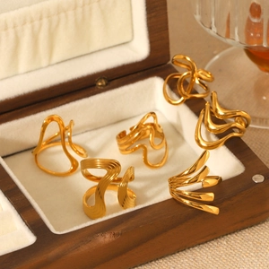Set of six gold-plated stainless steel rings with abstract geometric wave designs